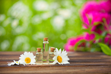 Essence of flowers on table in beautiful glass jar