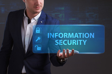 Business, Technology, Internet and network concept. Young businessman working on a virtual screen of the future and sees the inscription: Information security