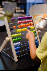 Close up on colorful abacus playful activity, educational interior background. Happy joyful developmental lifestyle