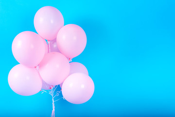 Pink birthday balloons on blue (cyan) background with copy space for text. Pink pastel party balloons, free space. Love, happiness, valentine, wedding honeymoon concept. Happy holiday flying balloons
