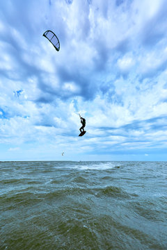 Kite Surfing on waves at sea in summer.