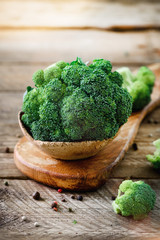 Fresh organic broccoli on wooden table close up with copyspace