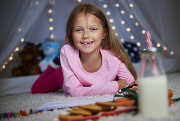 Cheerful girl posing while drawing .