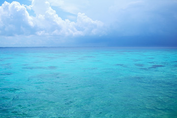 Thunderstorm and blue sky over the ocean
