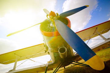 Part of a old small blue and white plane on a background of blue sky