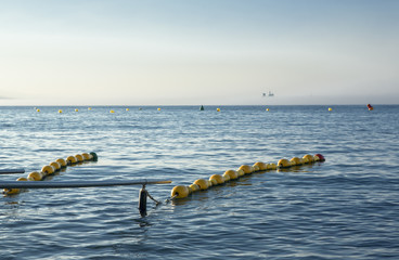 Handrails on beach for disabled people with ship at bottom in the mist