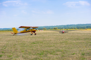 Fototapeta na wymiar Sailplane and a towing aircraft starting on an airfield