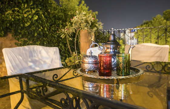 Moroccan tea party set up in a warm oriental candlelights atmosphere