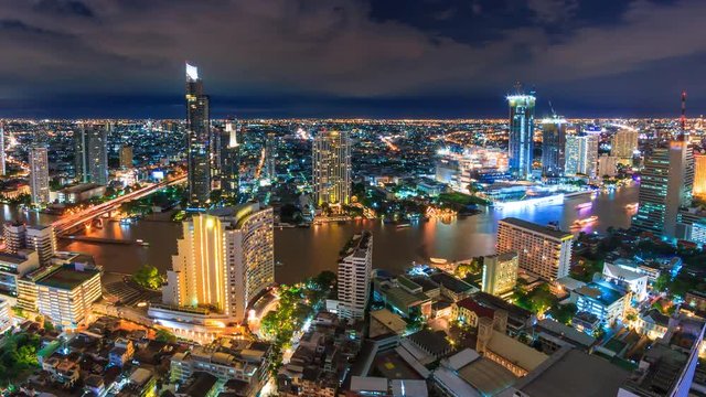 Aerial Bangkok Night Cityscape Riverside Chao Phraya River Of Thailand 4K Time Lapse (pan left)