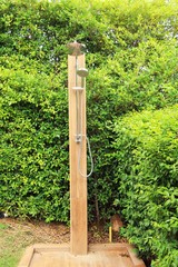 Outdoor shower with nature by the pool