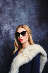 Model girl in furs and glasses