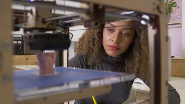 Female designer working with 3D printer in a design studio, shot on R3D