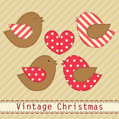 Cute fabric paradise birds as retro fabric applique in shabby chic style in traditional Christmas colors