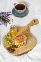 Breakfast with Belgian waffles, apricot jam and coffee