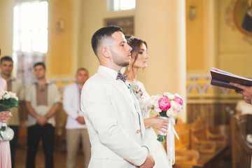 Wedding couple bide and groom get married in a church