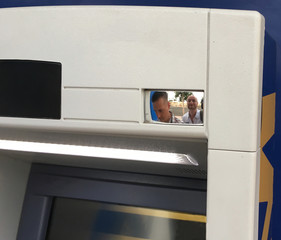 Two men having fun at a cash dispenser - 172967403