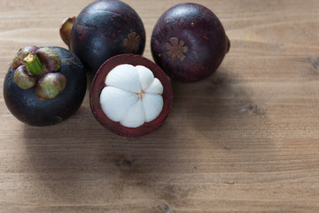 Fresh Mangosteen fruits on wood table top ,queen of fruit in Thailand