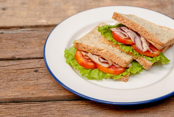 Fresh homemade club sandwich with lettuce and tomato
