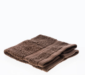 Fototapeta na wymiar Brown towel folded isolated on white background