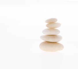 Balancing a stack of zen stones isolated on a white background