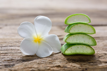 Fresh alo vera and plumeria spa flower on wooden background,spa treatment and body skin care concept