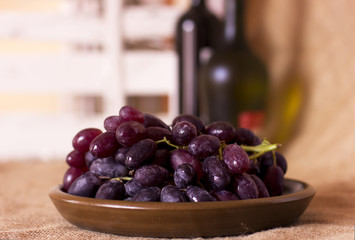 Blue grapes on a clay brown dish