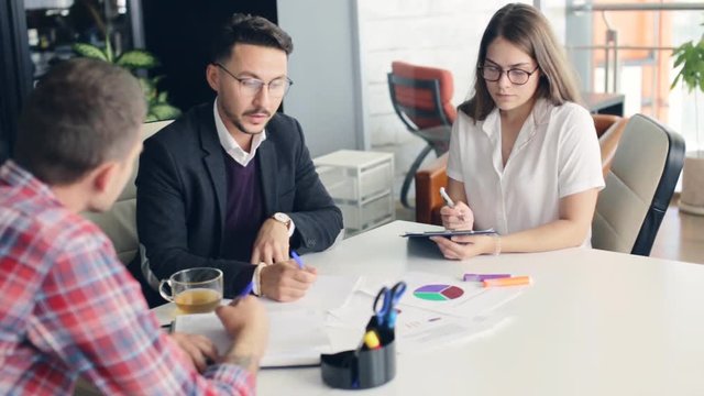 Group of business people working together in office.