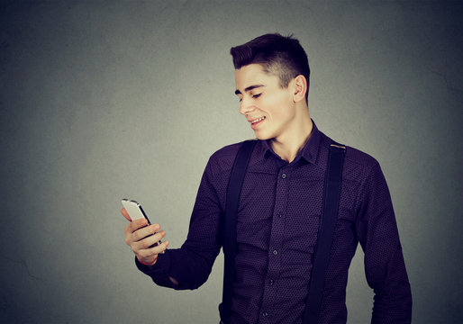 Young happy man using a mobile phone