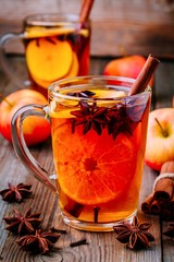 Hot mulled apple cider with with cinnamon sticks, cloves and anise