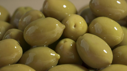 Large shiny green olives macro background