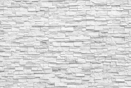 Surface white wall of stone wall gray tones for use as background. The new design of modern stone wall. pattern of decorative stone wall surface.