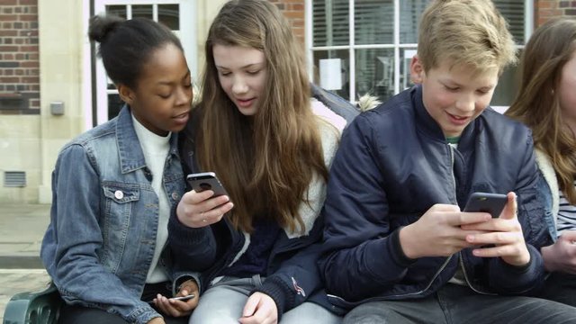 Teenage Friends In Town Using Mobile Phones Shot On R3D