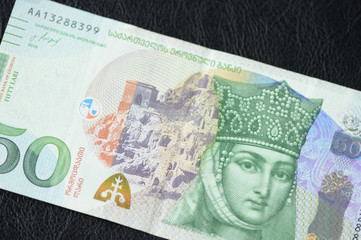 Georgian banknote in fifty lari on a dark background close up