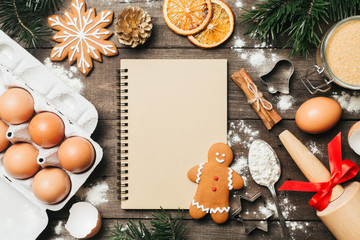 Fototapeta na wymiar Xmas baking or cooking background. Ingredients, kitchen items for baking cookies. Kitchen utensils, flour, eggs and sugar. Text space, top view.