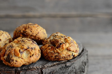 Homemade baked biscuits on a wooden background. Sweet biscuits with walnuts. Closeup