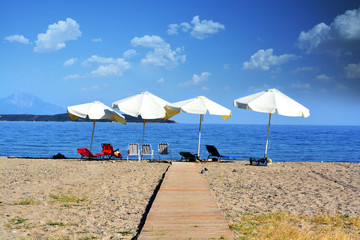 Fototapeta na wymiar Relax concept, empty beach with parasols and chairs