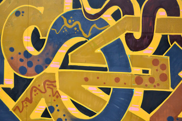 Background image with graffiti elements. Texture of the wall, painted in different colors of in the graffiti style. Concept of street culture, youth entertainment and illegal hooliganism