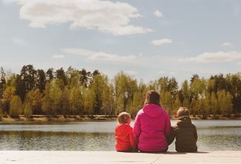 Fototapeta premium mother with two kids looking at autumn nature