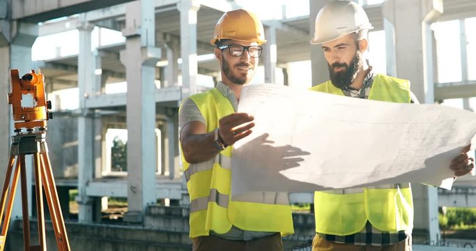 Portrait of construction engineers working on building site