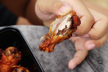 The boy eating fried chicken is delicious