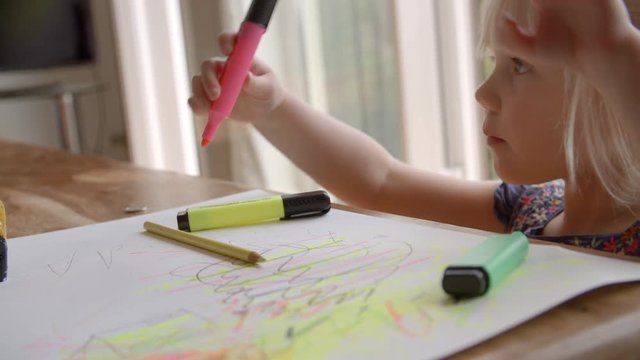 Girl Sitting At Table And Drawing Picture In Slow Motion