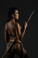 Horsewoman with blue African braids rearview