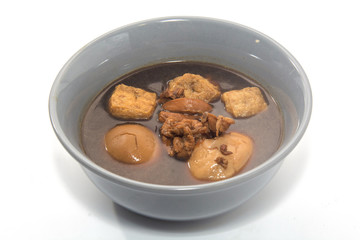 Eggs boiled stewed in the gravy on white background