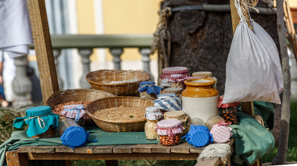 Jars and baskets with ecological products, exposed in an ecological market