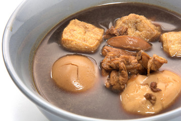 Eggs boiled stewed in the gravy on white background