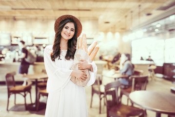 cute young girl carries bread in her hands