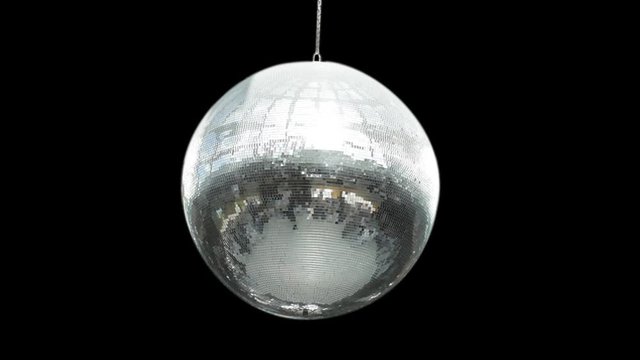 silver mirror disco ball rotating in black space