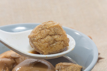 Eggs boiled stewed in the gravy on white background