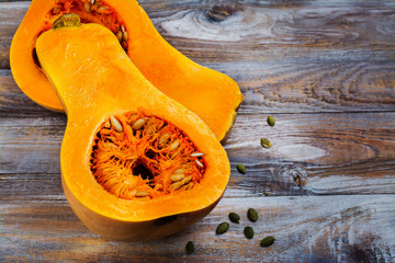 Raw cut butternut pumpkin on kitchen table. Space for text