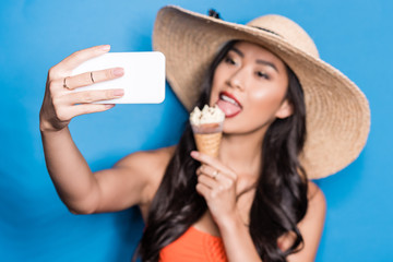 Fototapeta premium Woman taking selfie with ice-cream